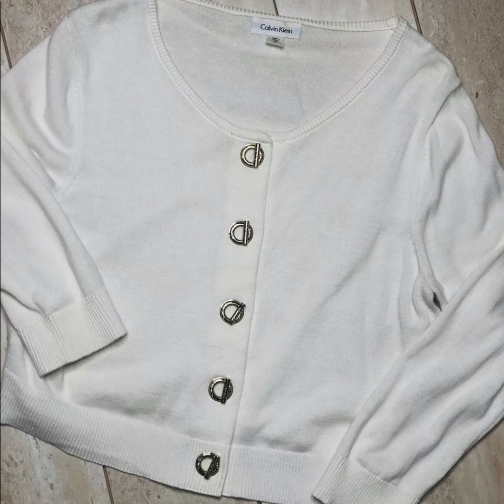 Calvin Klein Shrug with gold toggle buttons.